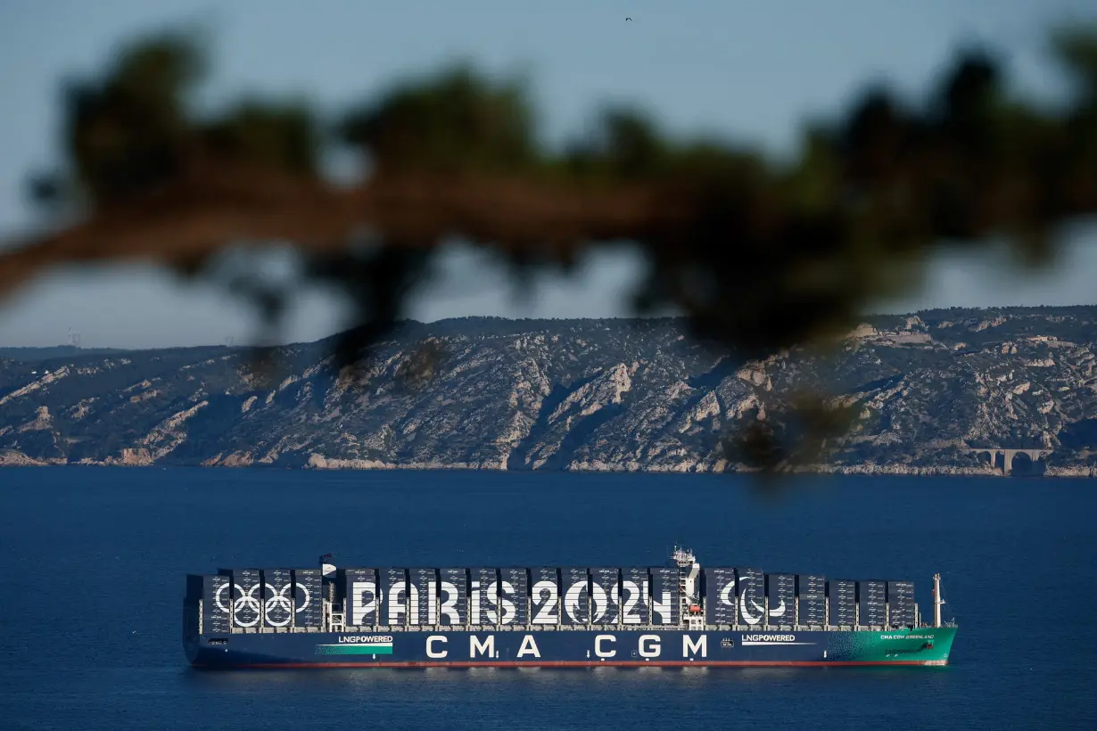 The CMA CGM Greenland container ship is seen at sea with Paris 2024 and the Olympic rings on it during the Olympics torch relay ahead Paris 2024 Olympic games