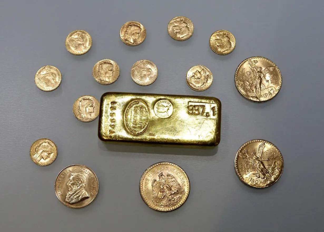 FILE PHOTO: A gold ingot and gold coins are seen in this illustration picture