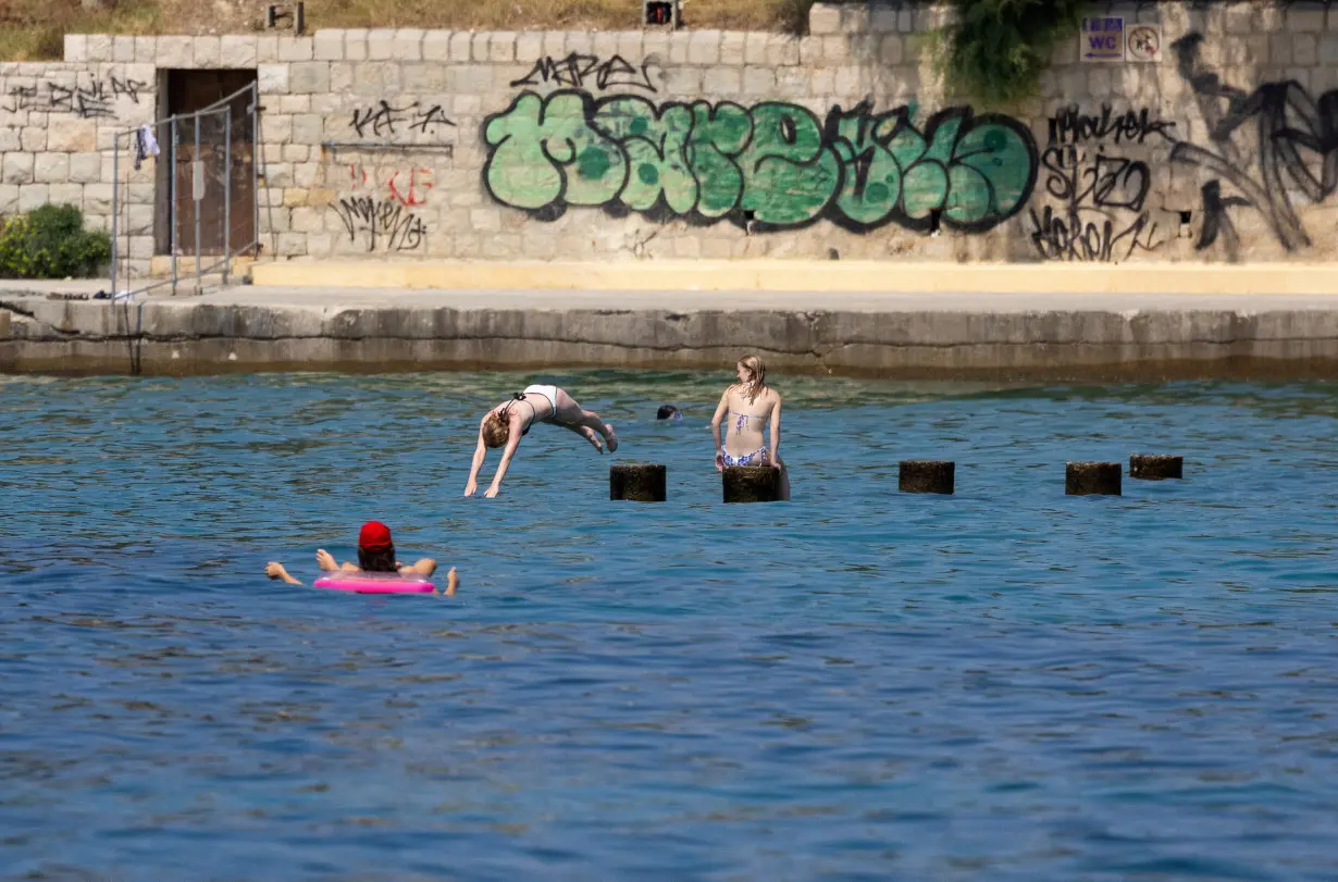 A girl plunges into the Adriatic Sea in Split