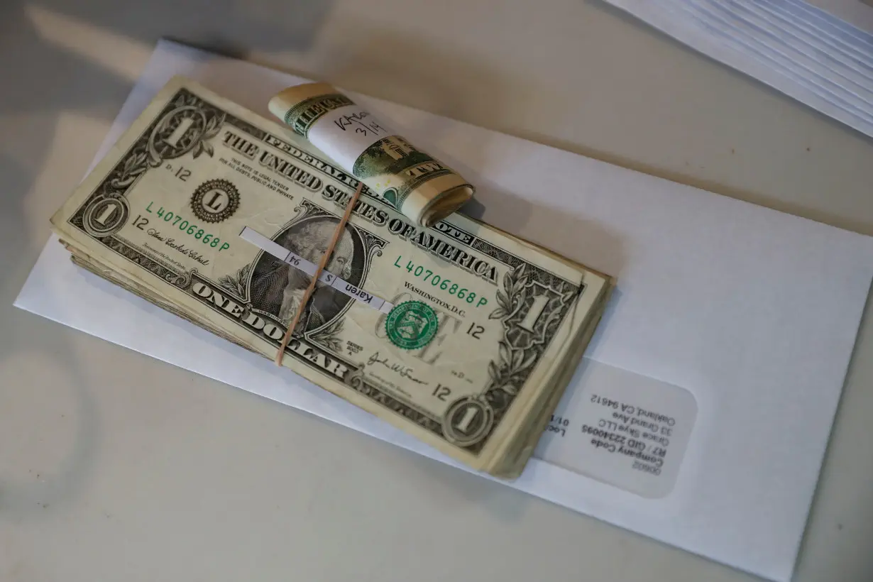 Tips, money collected from a customer donation fund and a last paycheck for employees laid off from Farley's East cafe, that closed due to the financial crisis caused by the coronavirus disease (COVID-19), sits on a counter at the cafe in Oakland