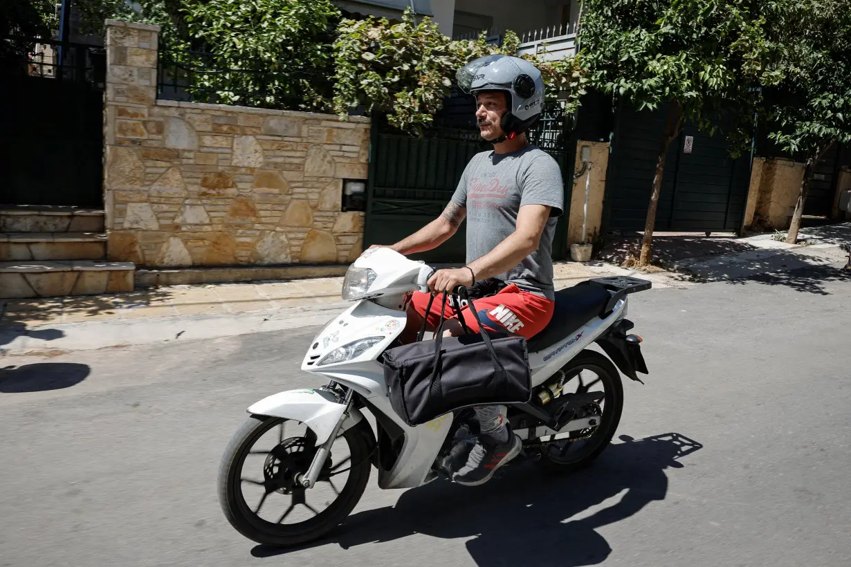 A delivery worker during a heatwave as authorities issue measures for workers