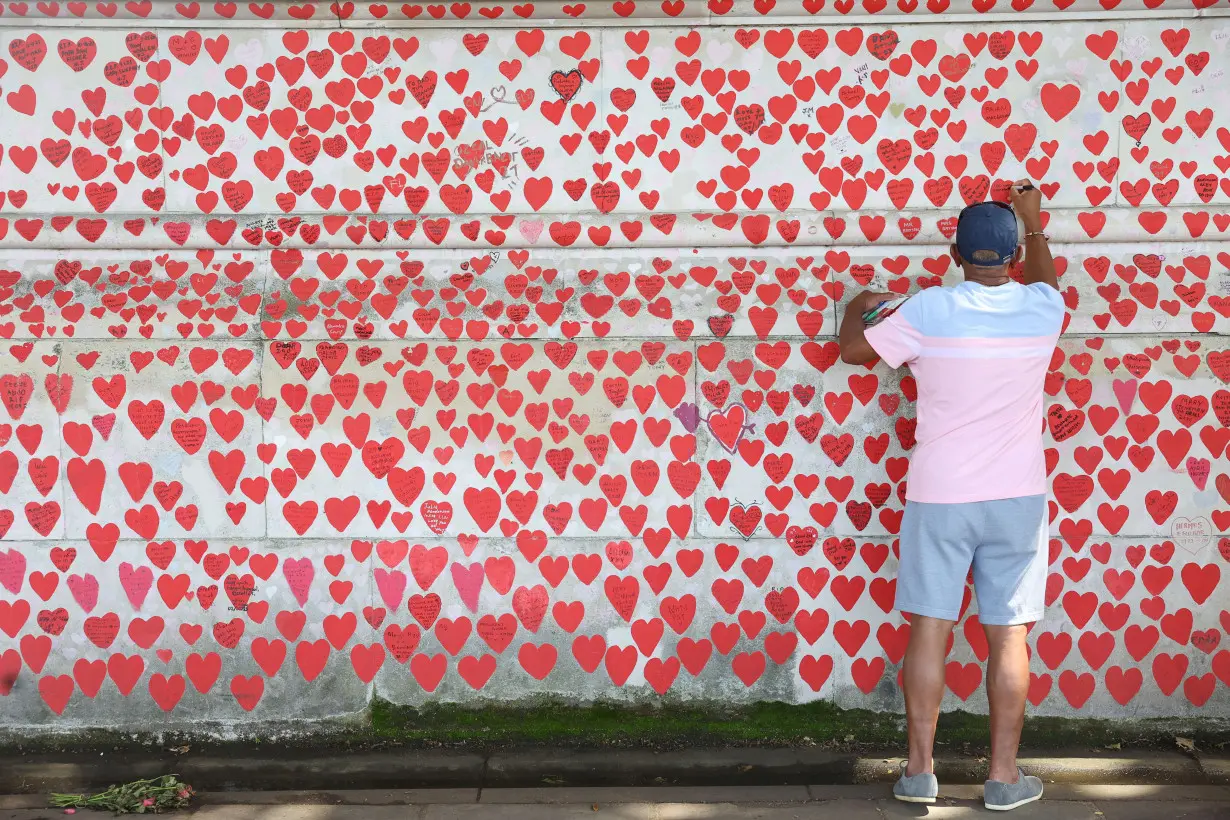 People visit the National Covid Memorial Wall, as the first report from the public inquiry examining Britain's response to the COVID-19 outbreak is published, in London