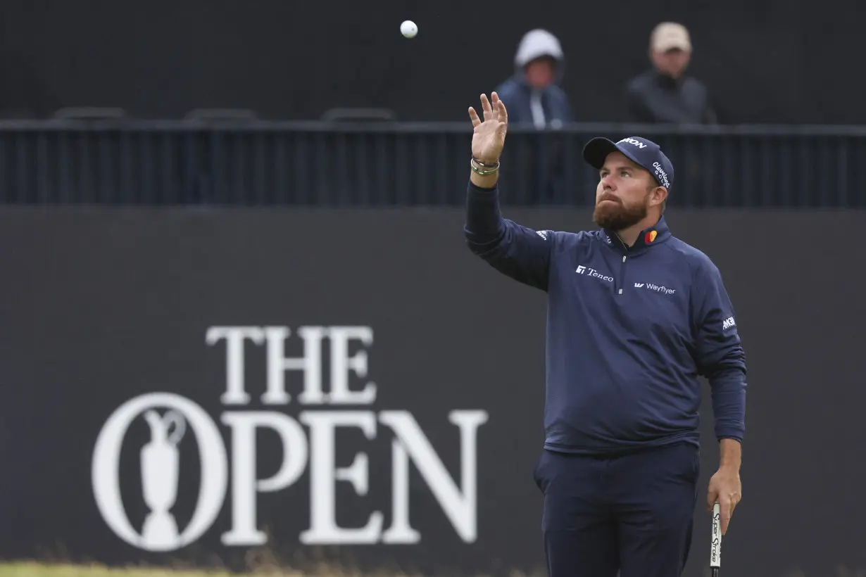 Daniel Brown makes late birdies for a 1-shot lead over Shane Lowry in wind-challenged British Open