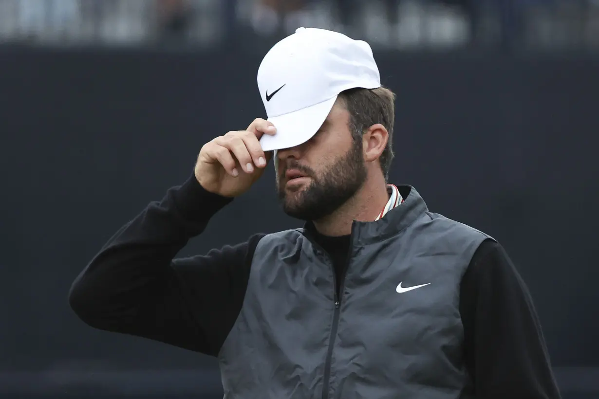 Daniel Brown makes late birdies for a 1-shot lead over Shane Lowry in wind-challenged British Open