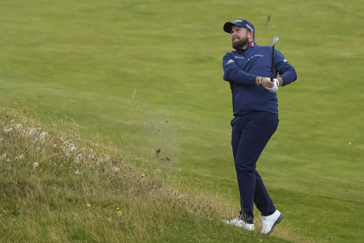 Daniel Brown makes late birdies for a 1-shot lead over Shane Lowry in wind-challenged British Open