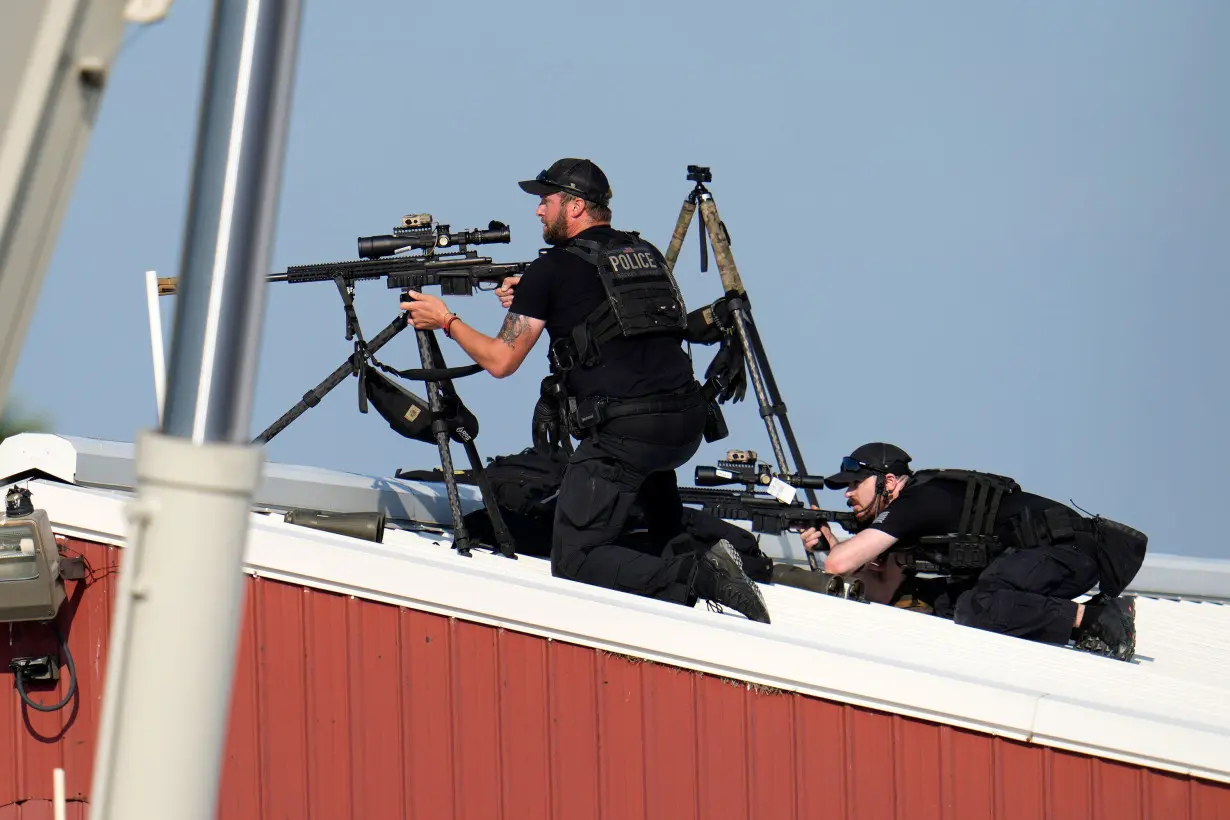 Law enforcement snipers return fire after shots were fired while former President Donald Trump was speaking at his rally.