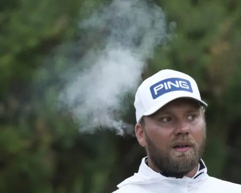 Daniel Brown makes late birdies for a 1-shot lead over Shane Lowry in wind-challenged British Open