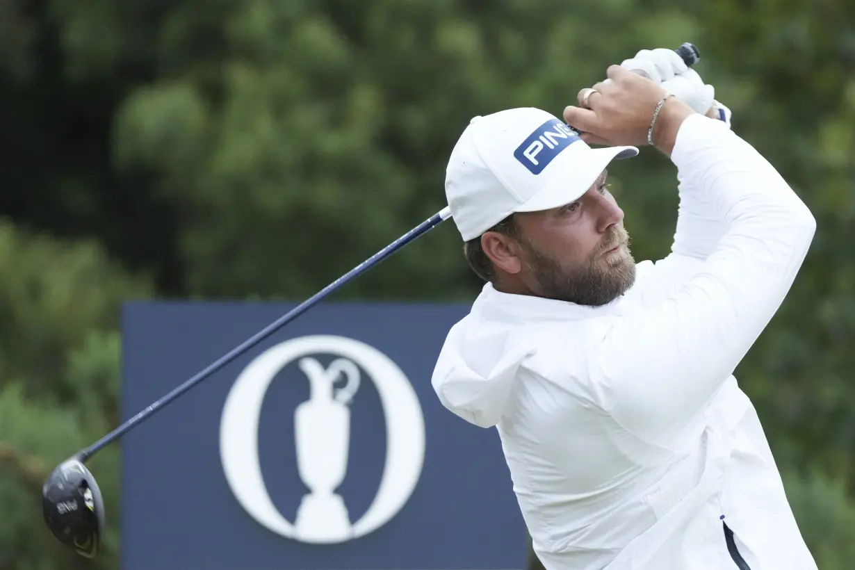 Daniel Brown makes late birdies for a 1-shot lead over Shane Lowry in wind-challenged British Open