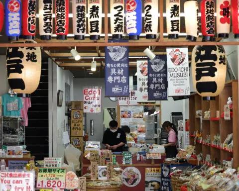 Japan cuts growth forecast, prime minister warns of weak-yen pain