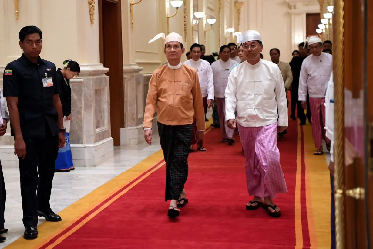 FILE PHOTO: Newly elected Myanmar President Win Myint (C) and Vice President Myint Swe arrive at the presidential palace at Naypyitaw