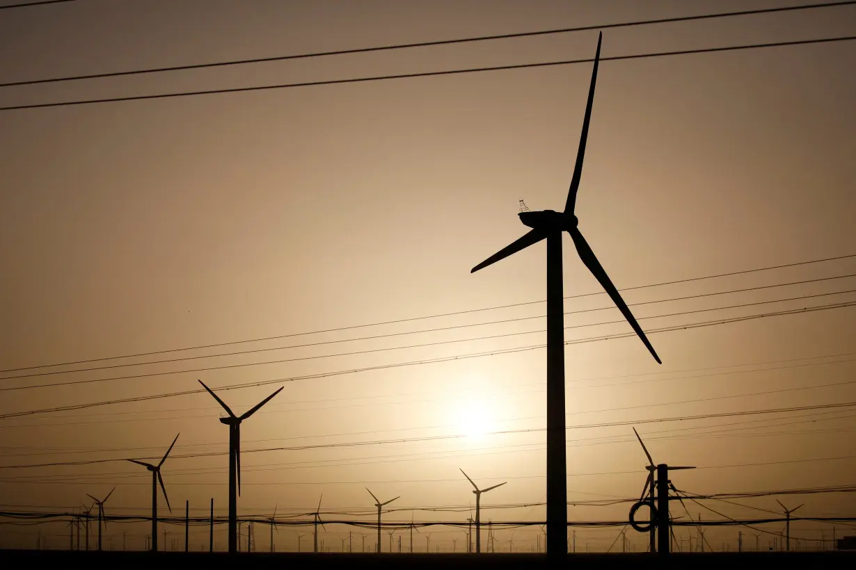 FILE PHOTO: Wind turbines stand on a power station near Yumen