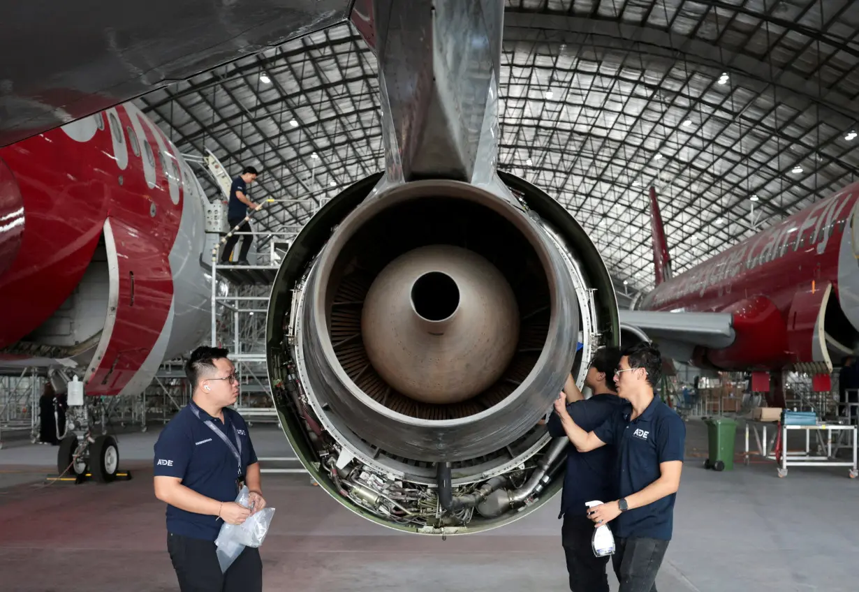 FILE PHOTO: Technicians inspect an aircraft engine in the maintenance hangar of Asia Digital Engineering at Subang