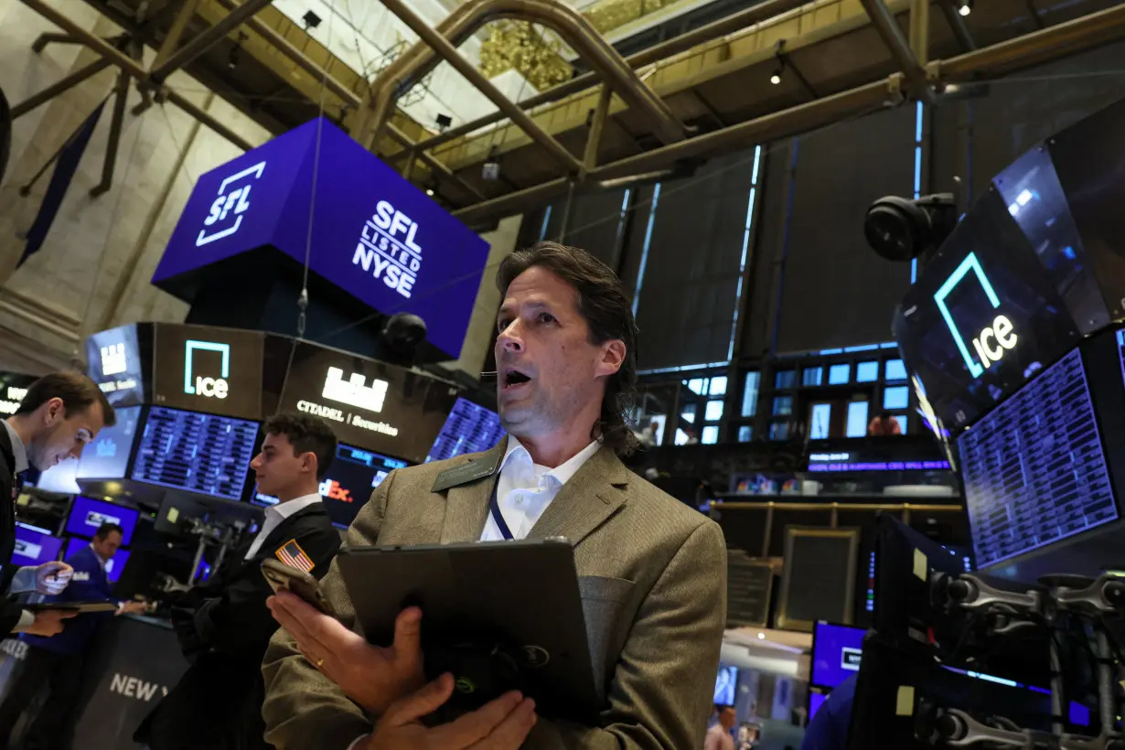 Traders work on the floor of the NYSE in New York