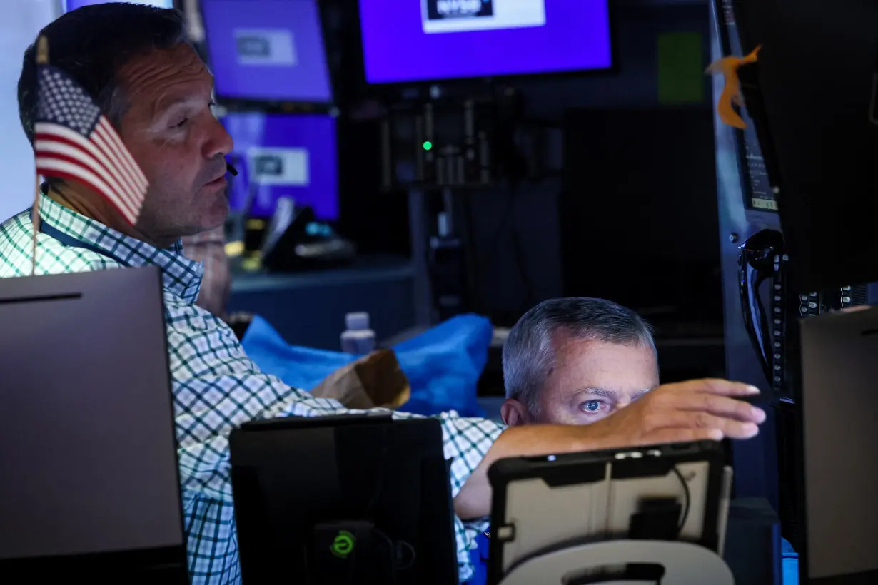 Traders work on the floor of the NYSE in New York