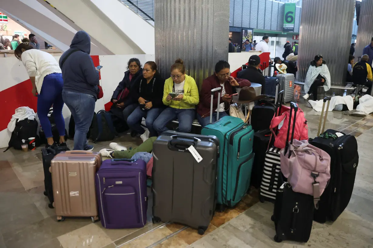 Passengers wait at the Benito Juarez International Airport due to a worldwide tech outage that caused flight delays, in Mexico City