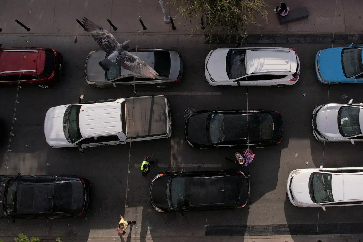 Cars line up to cross into the United States, after a global technological disruption that caused a delay at the international crossing, in Ciudad Juarez