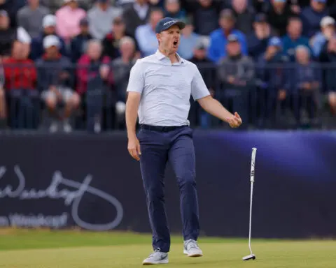 Golf-Lowry leads Open, Rose blooms and Scheffler in the hunt