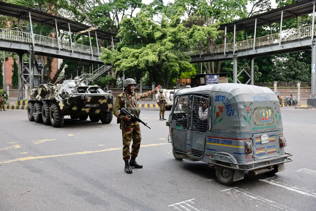 Members of the Bangladesh Army are seen on duty on the second day of curfew, in Dhaka