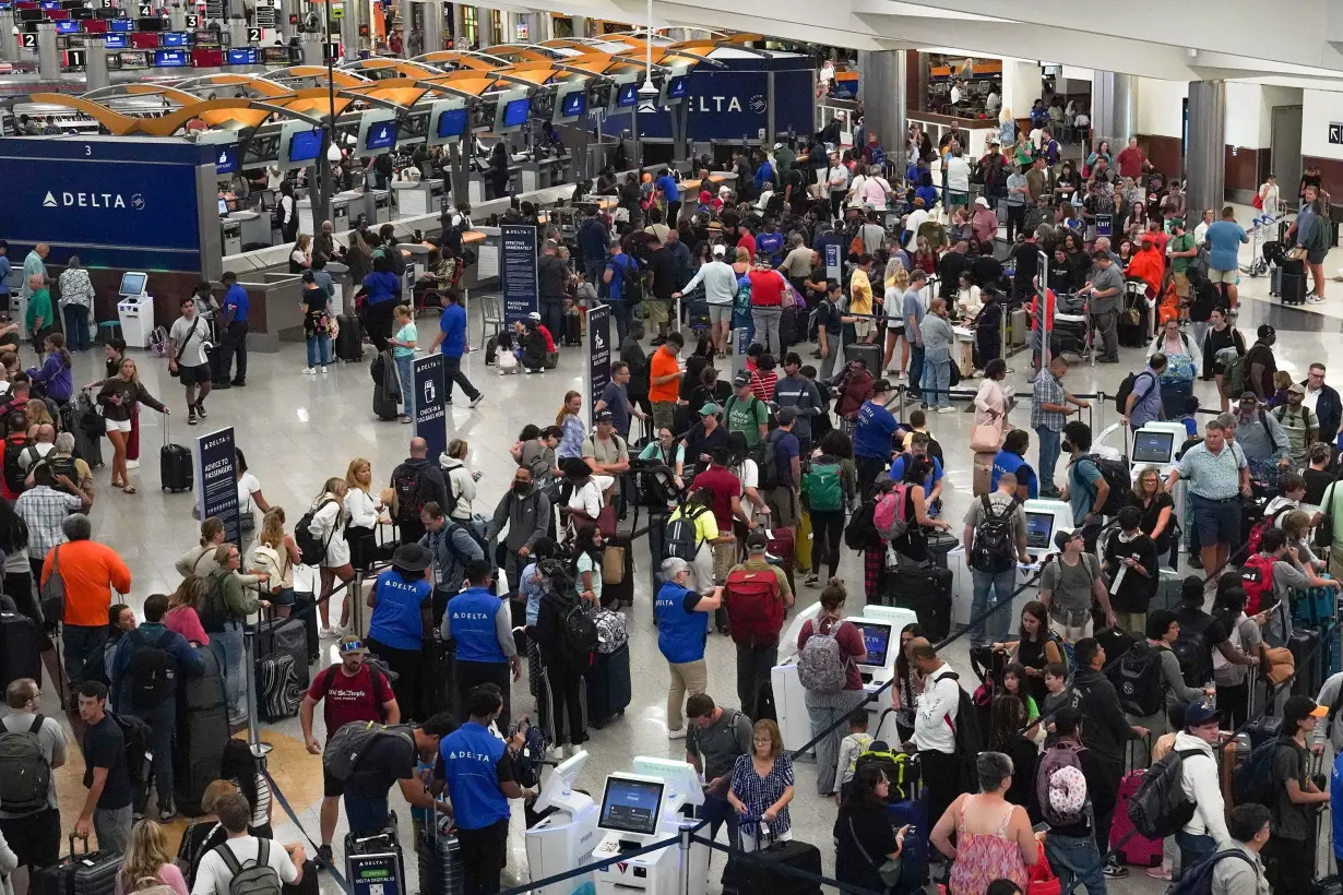 People wait in line at Hartsfield-Jackson International Airport on July 20 in Atlanta, Georgia.