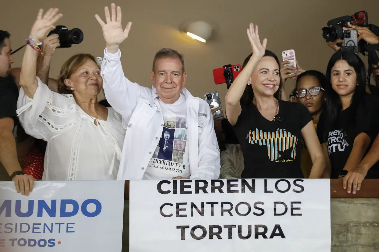 Venezuelan opposition presidential candidate Edmundo Gonzalez and opposition leader Maria Corina Machado wave to supporters at the Central University of Venezuela UCV in Caracas on July 14, 2024.