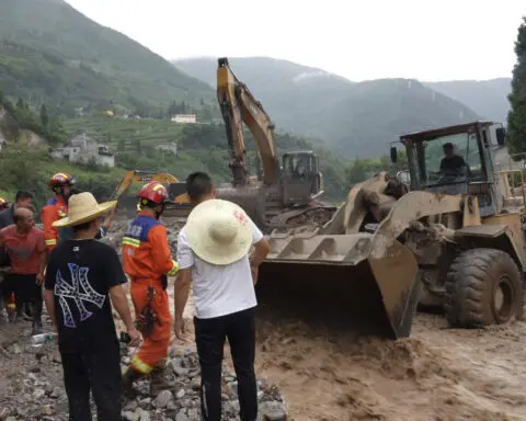 Rescuers search for dozens missing after flooding and a bridge collapse in China kill at least 25