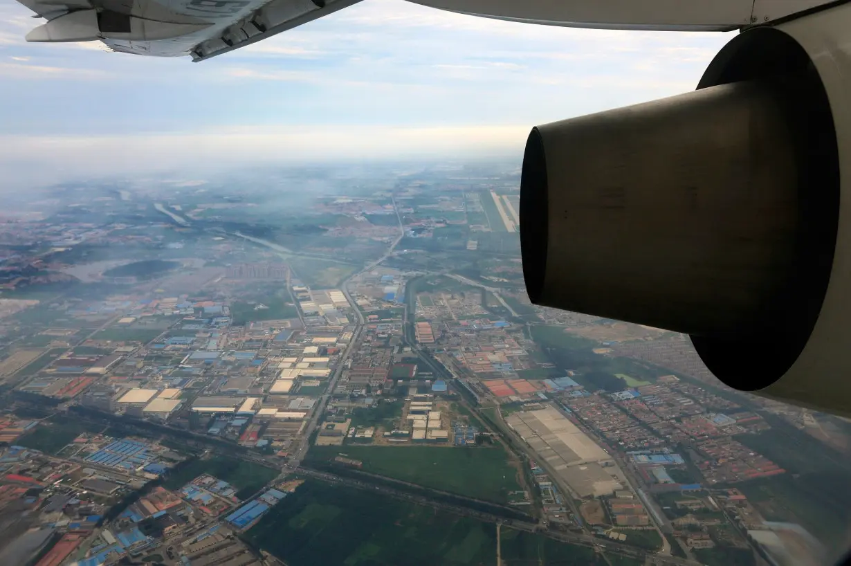 Factories and residential areas are pictured from the window of an aircraft north of Beijing