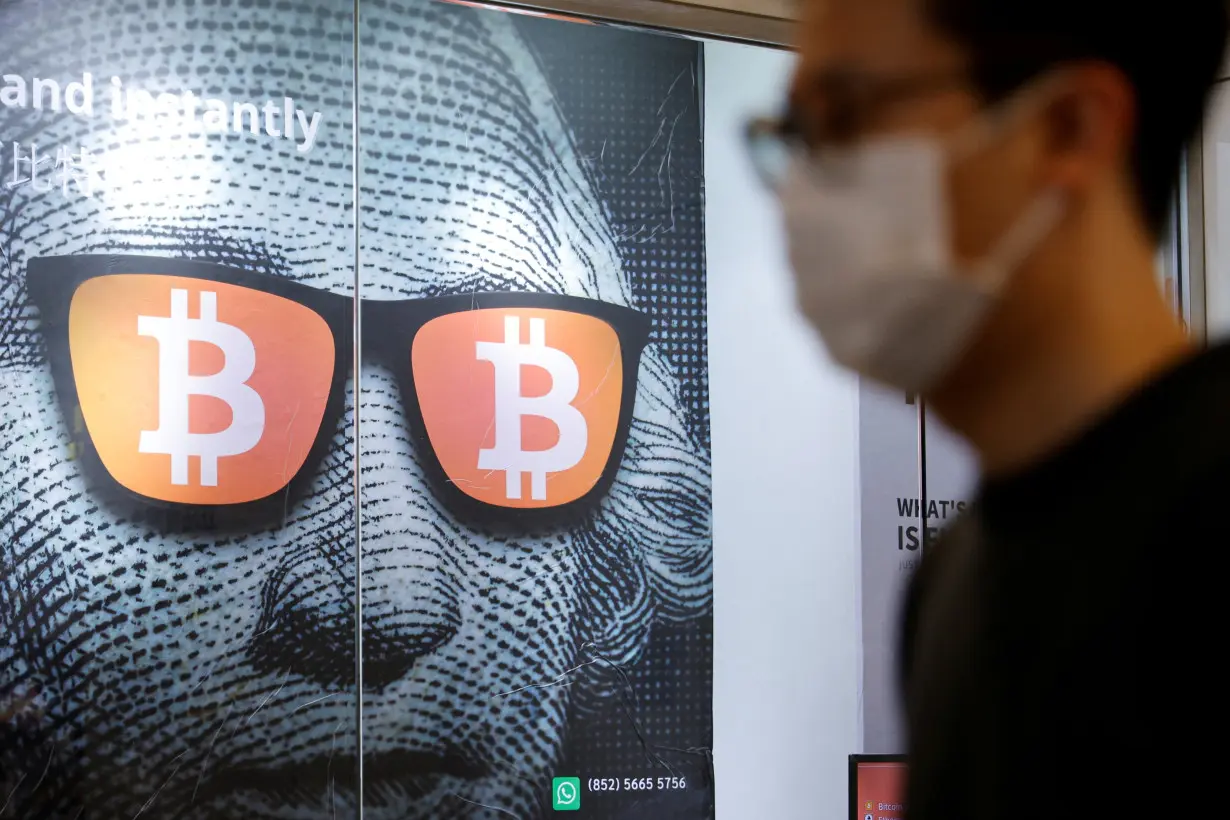 FILE PHOTO: An advertisement for Bitcoin and cryptocurrencies is seen in Hong Kong