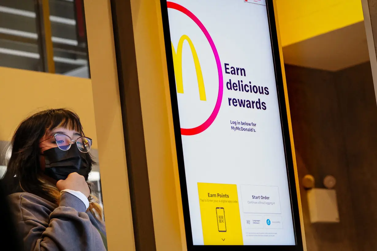 A customer enters their order into a kiosk at a McDonald's in New York