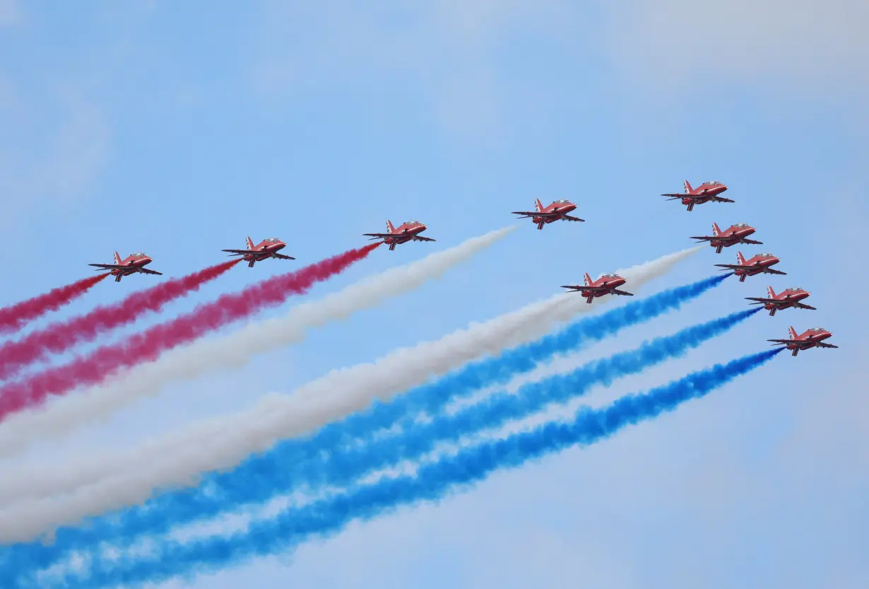 The British Red Arrows display team fly at Farnborough International Airshow, in Farnborough