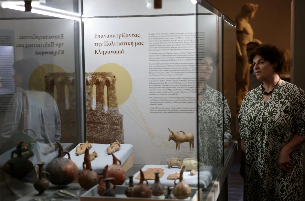 A woman looks at artefacts dating back to the Chalcolithic and Bronze Age period at the Cyprus Museum in Nicosia