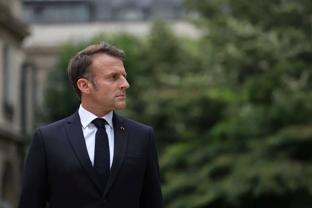 French President Emmanuel Macron reviews troops that will take part in the Bastille Day parade, in Paris