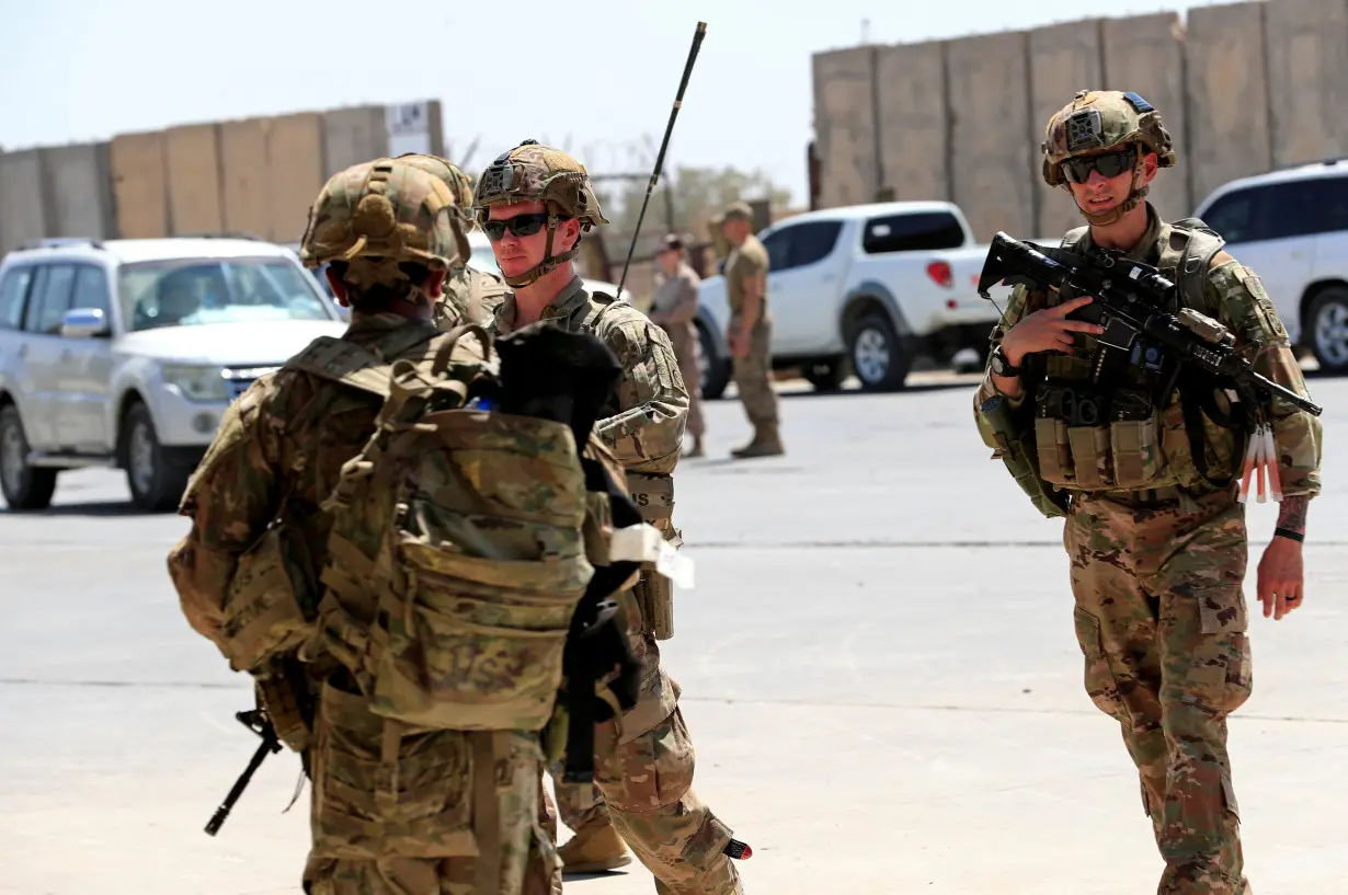 FILE PHOTO: U.S.-led troops withdraw from Iraq's Taji base