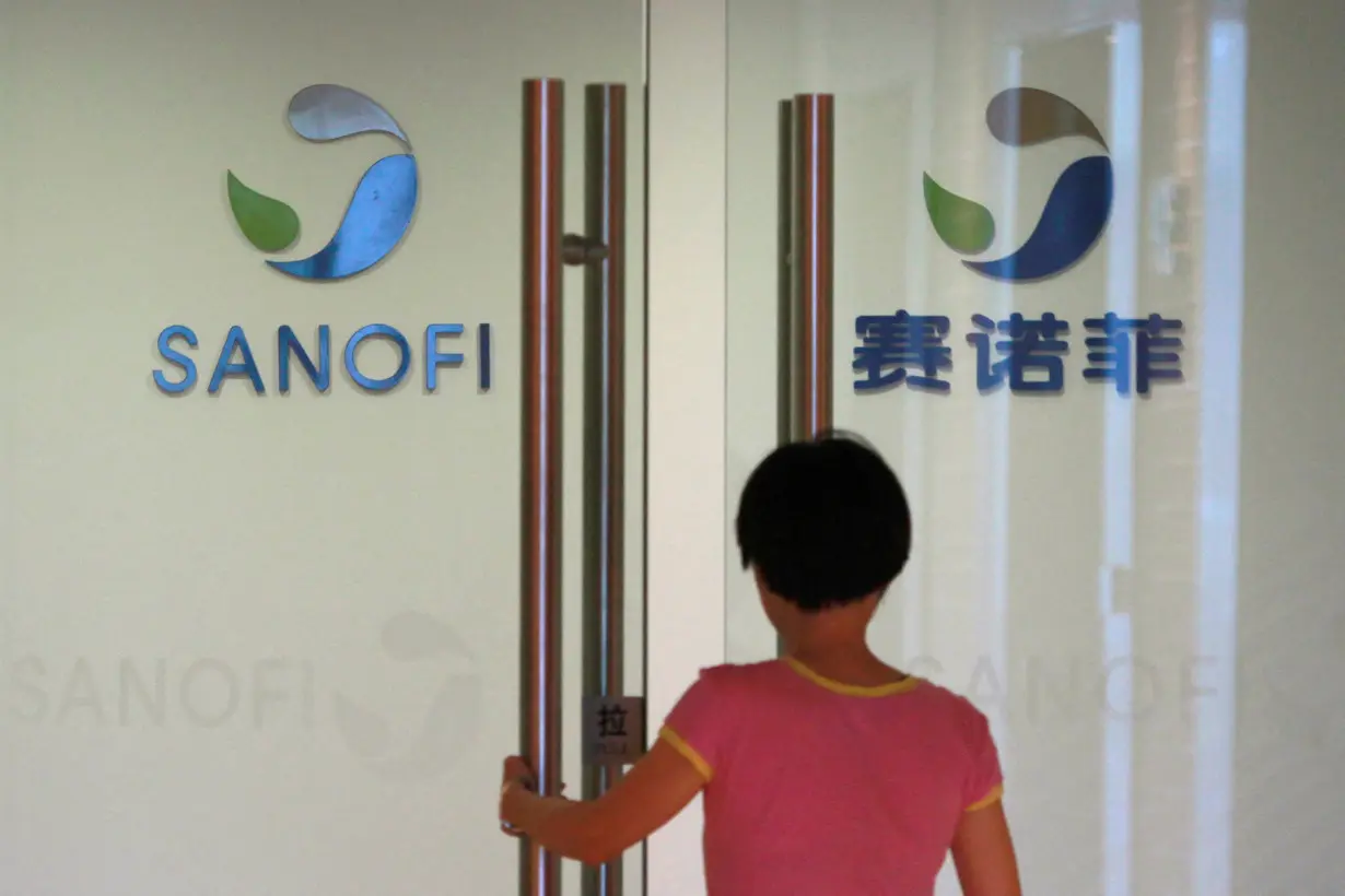 Employee walks into an office of French drugmaker Sanofi in Shanghai