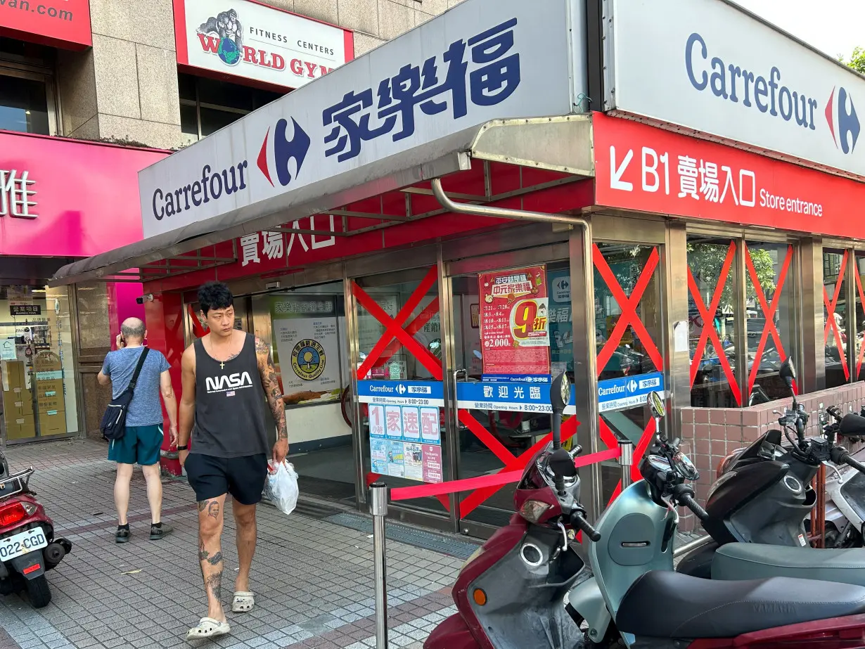 A supermarket window is seen taped up to prepare for typhoon Gaemi in Taipei