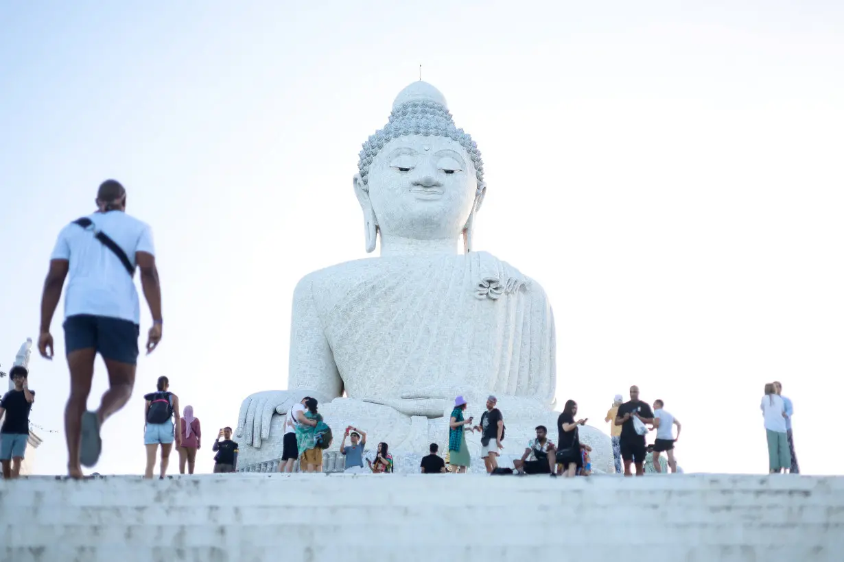 Tourists visit the Big Buddha statue in Phuket