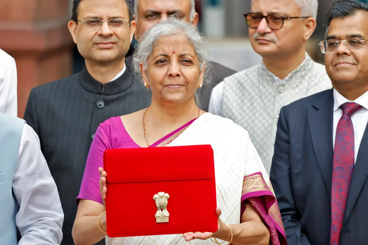 India's Finance Minister Nirmala Sitharaman holds up a folder with the Government of India's logo, in New Delhi