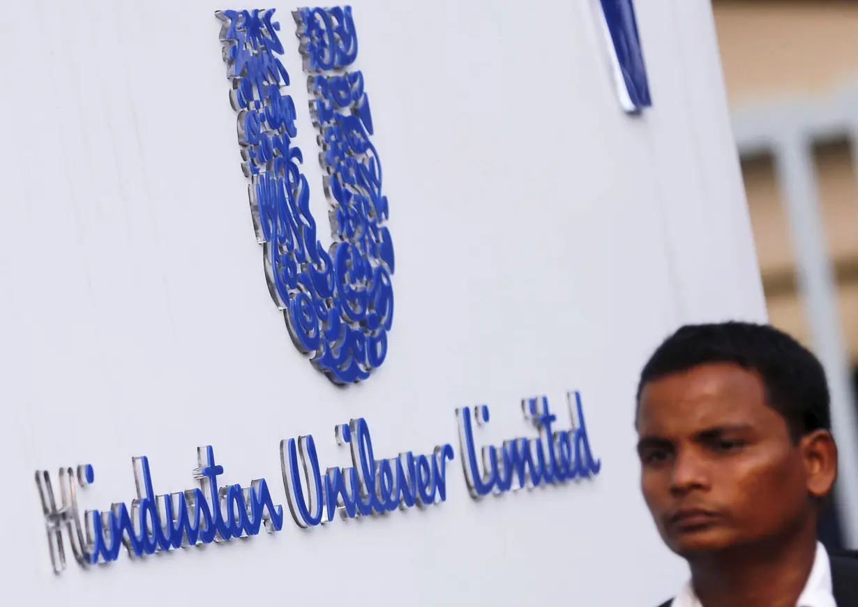 A pedestrian walks past the logo of HUL at its headquarters in Mumbai