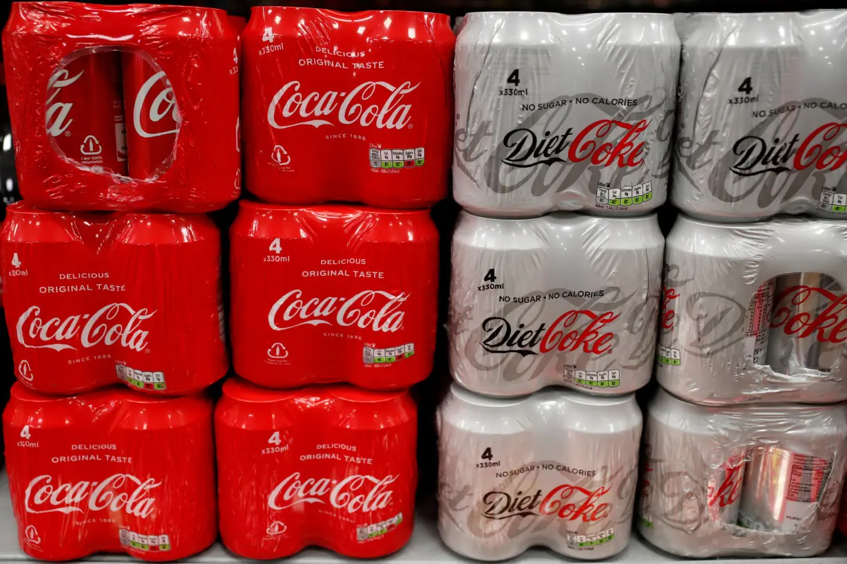 Multi can packs of Coca Cola and Diet Coke are seen for sale in a motorway services shop, Reading