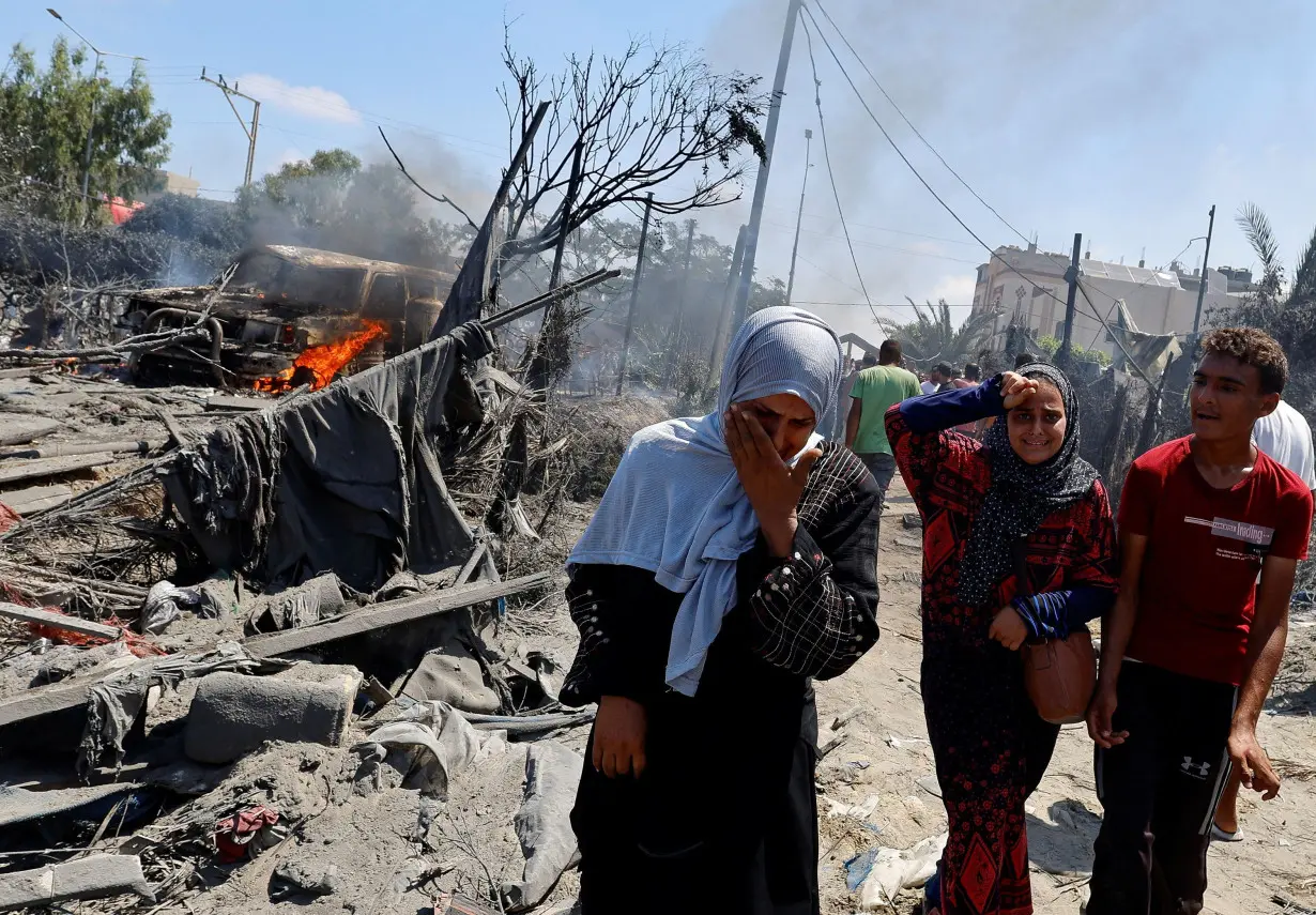 Palestinians react near damages, following what Palestinians say was an Israeli strike at a tent camp in Al-Mawasi area, amid Israel-Hamas conflict, in Khan Younis in the southern Gaza Strip July 13.