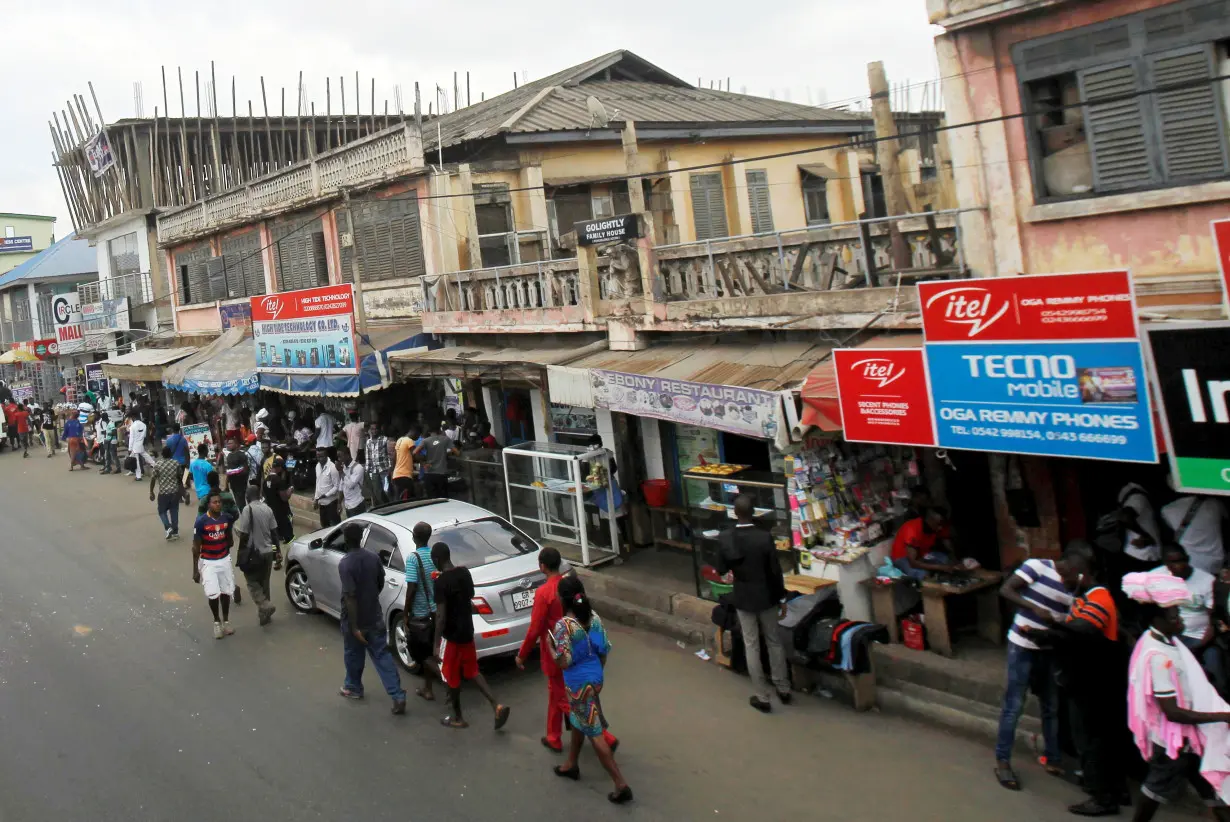 People walk on the street around Kwame Nkrumah circle in Accra