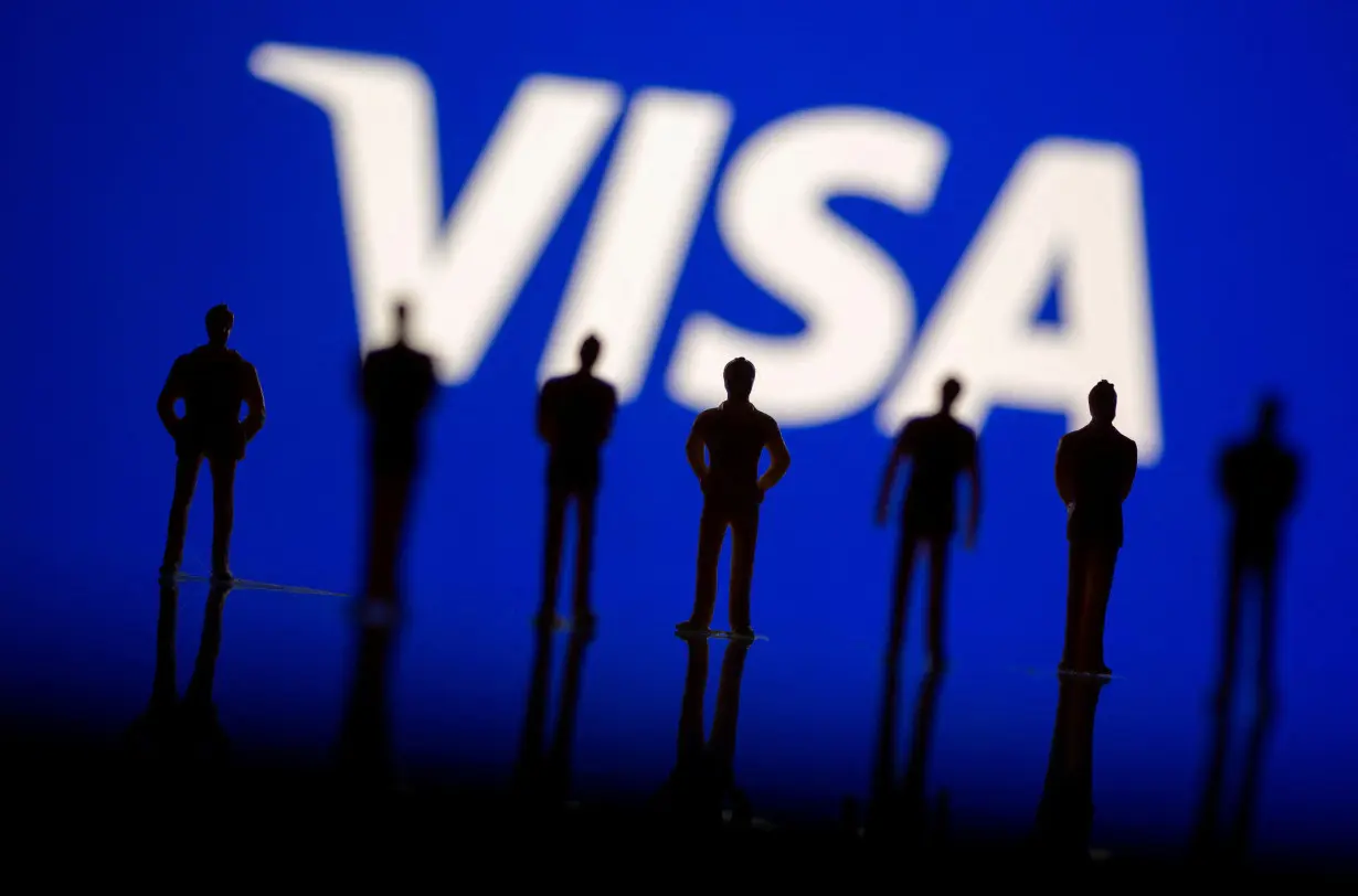 FILE PHOTO: Small toy figures are seen in front of displayed Visa logo in this illustration taken