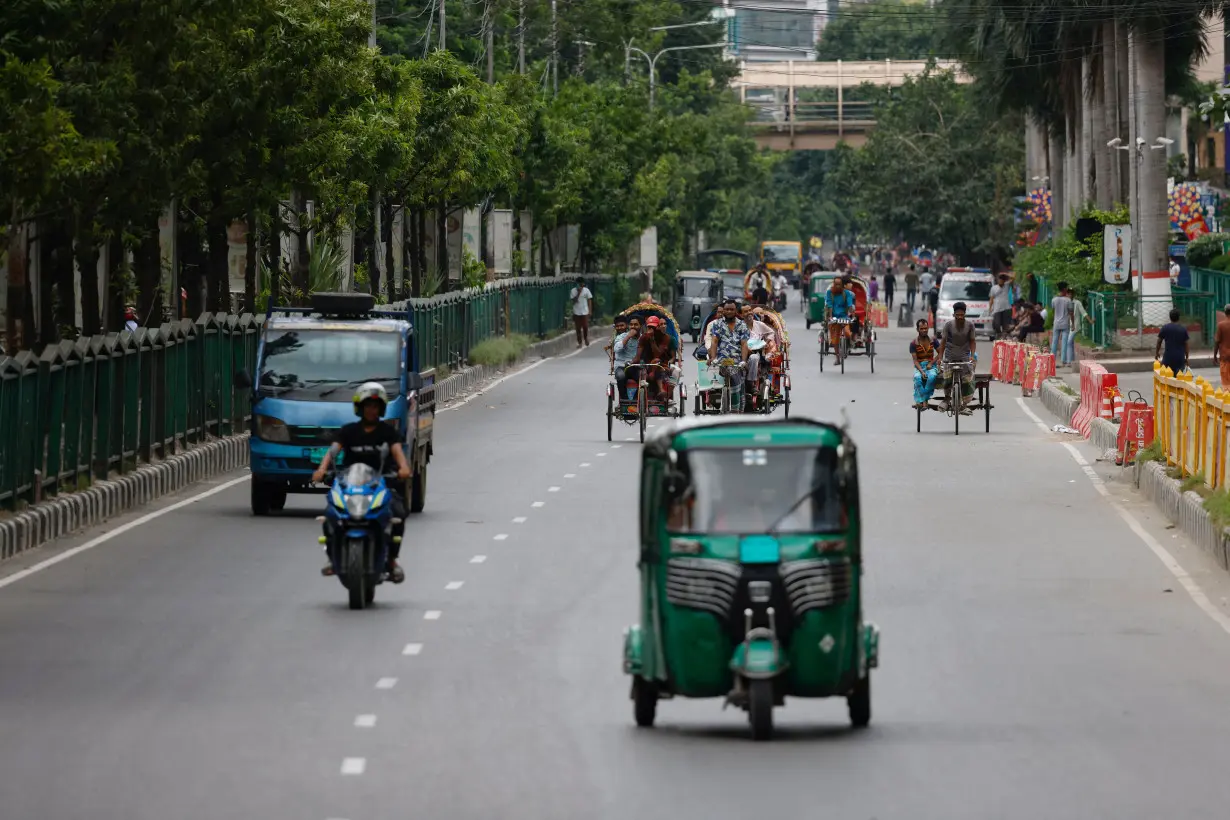 Limited vehicles move on a street on the second-day of curfew, in Dhaka