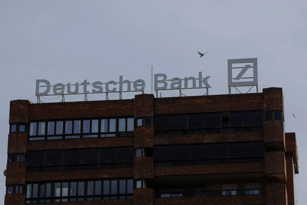 FILE PHOTO: The logo of Deutsche Bank is seen on the roof of a building outside a Deutsche Bank branch office in Malaga