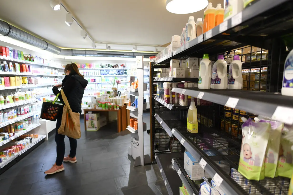 Partially emptied shelves are pictured in a supermarket in Munich