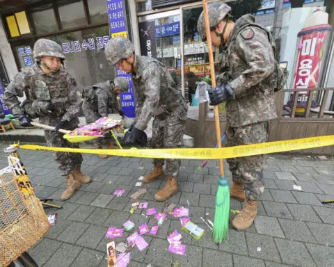 Trash dropped by a North Korean balloon falls on South Korea’s presidential compound