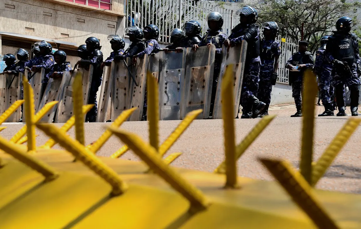 FILE PHOTO: Ugandan security forces detain young protesters marching in Kampala