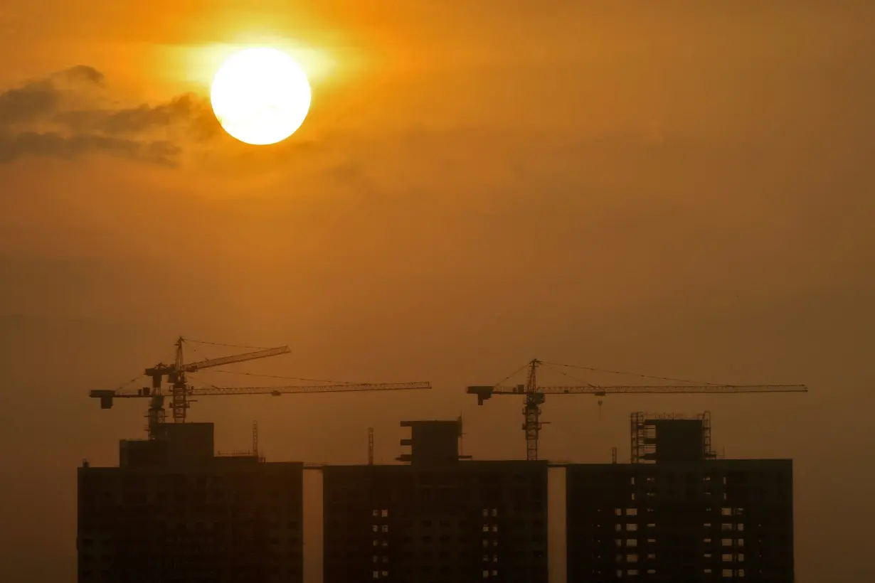 FILE PHOTO: Construction sites of commercial buildings are seen as the sun sets in Colombo