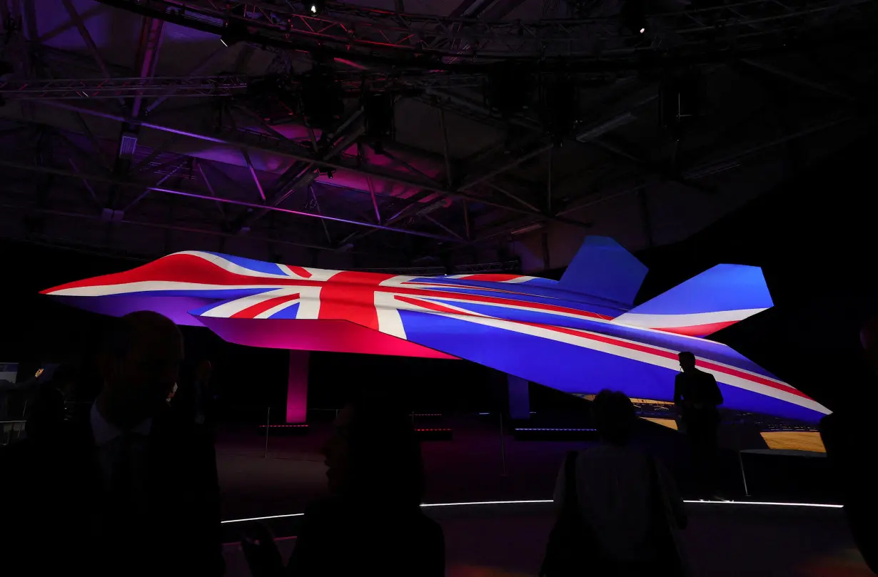 FILE PHOTO: Attendees view GCAP concept fighter plane at the BAE Systems pavilion at Farnborough International Airshow, in Farnborough