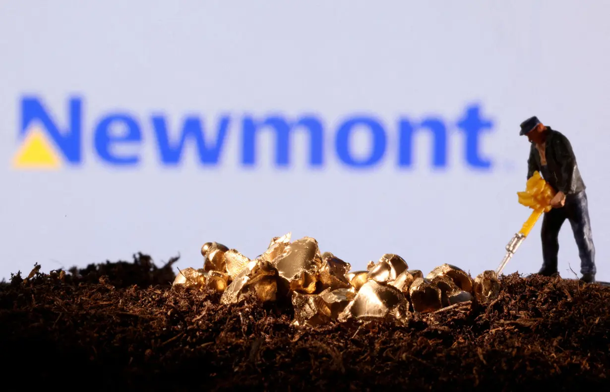 FILE PHOTO: FILE PHOTO: Small toy figure and gold imitation are seen in front of the Newmont logo in this illustration