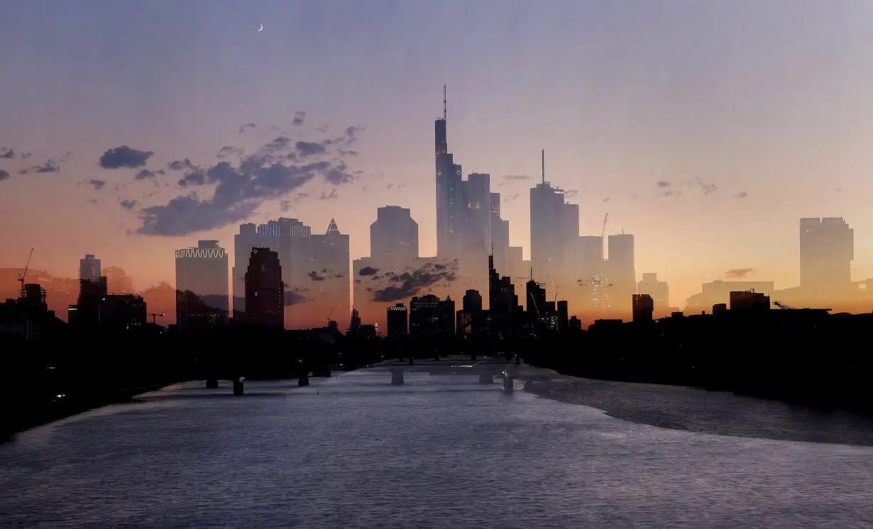 FILE PHOTO: The sun sets behind the skyline of Frankfurt